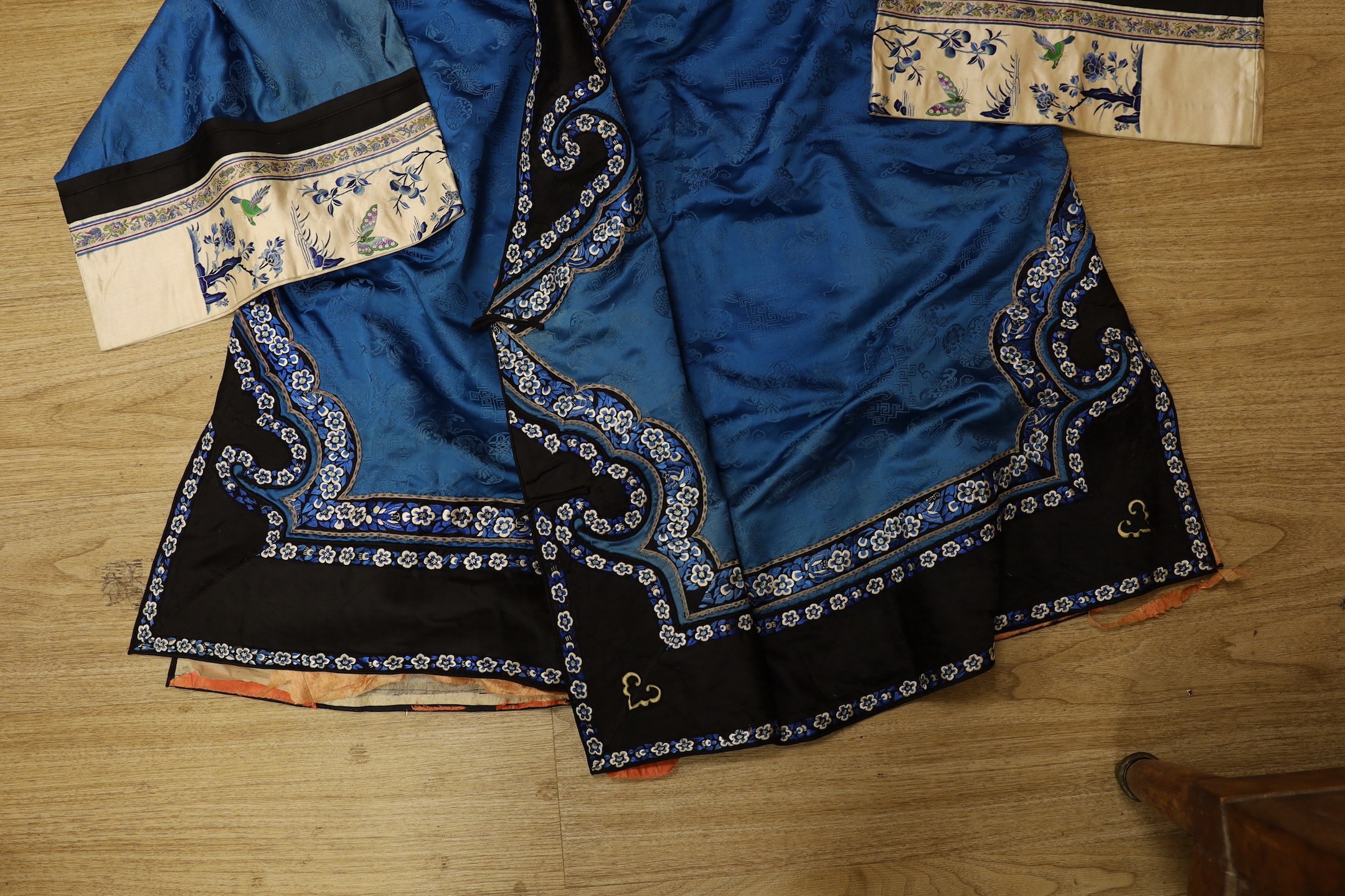 A Chinese silk robe, a 19th century patchwork panel and a panel from a Paisley summer shawl and a black parasol